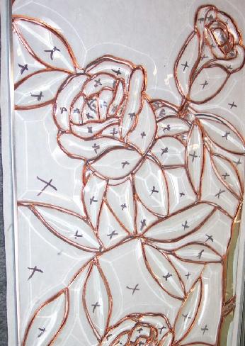 This panel is made up of all clear glass bevels of differing thickness and age. The oldest glass in it is from about 1910, and has a warm yellow appearance. The newest is Starphire, almost totally clear.